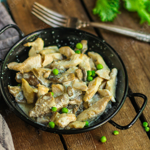 chicken with mushrooms in a creamy sauce - snacks. healthy food and menu. copy space