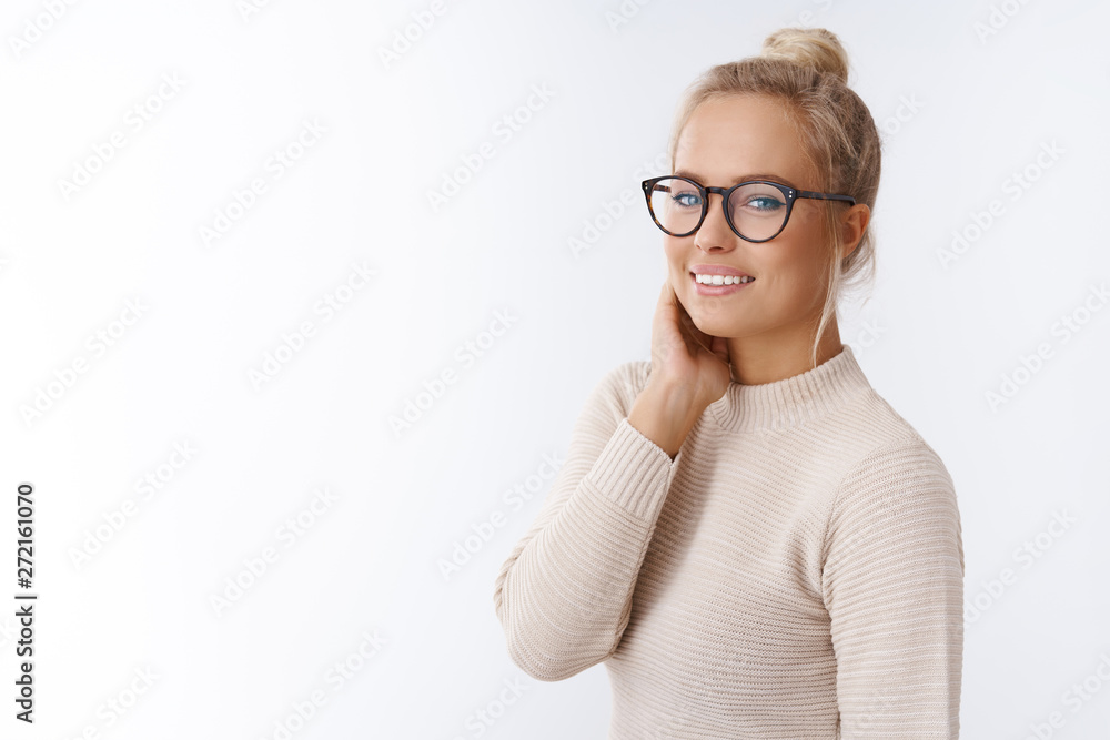 Tenderness, sensuality and beauty concept. Beautiful gentle and stylish young woman with pure clear skin wearing glasses turning at camera touching face smiling gently expressing positive attitude Tenderness, sensuality and beauty concept. Beautiful gentle and stylish young woman with pure clear skin wearing glasses turning at camera touching face smiling gently expressing positive attitude