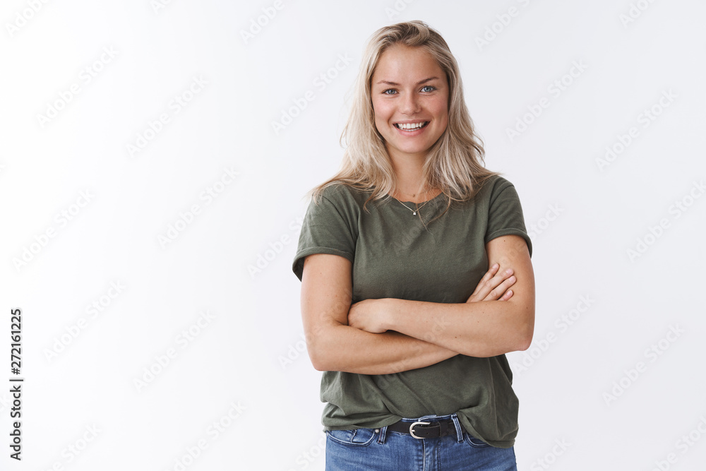Young friendly-looking attractive mother talking other moms during b-day party crossing arms over body and smiling pleasantly at camera having fun amusing talk, posing against white background Young friendly-looking attractive mother talking other moms during b-day party crossing arms over body and smiling pleasantly at camera having fun amusing talk, posing against white background