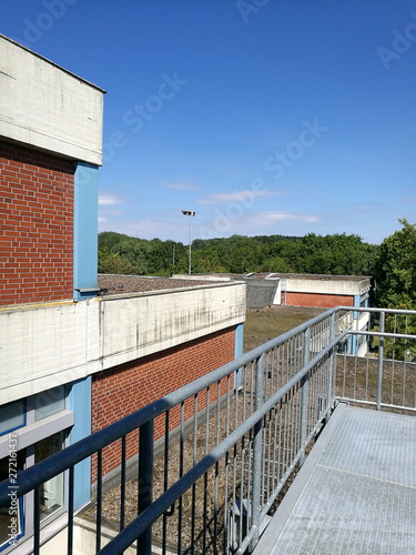 Moderne Architektur mit rotbraunem Klinker des Niklas-Luhmann-Gymnasium im Sommer bei blauem Himmel und Sonnenschein in Oerlinghausen bei Bielefeld am im Teutoburger Wald in Ostwestfalen-Lippe photo