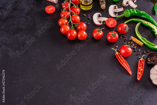 Ingredients for preparation of tasty Italian pizza. Cherry tomato, spices, basil, chili pepper