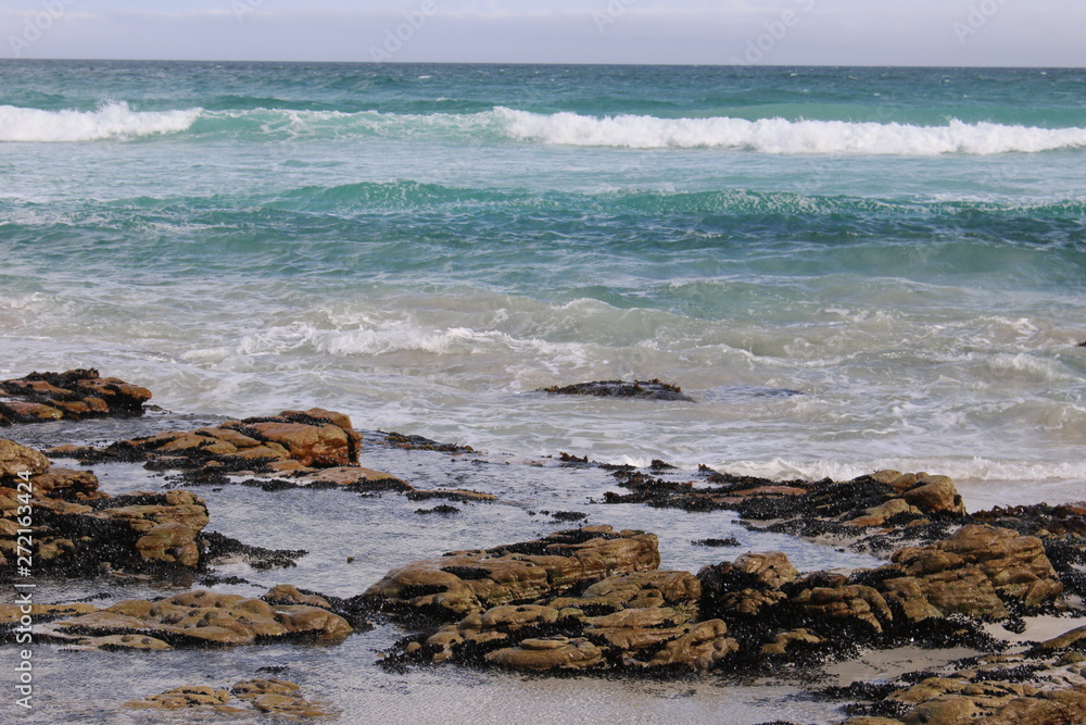 Blue Ocean waves over rocks