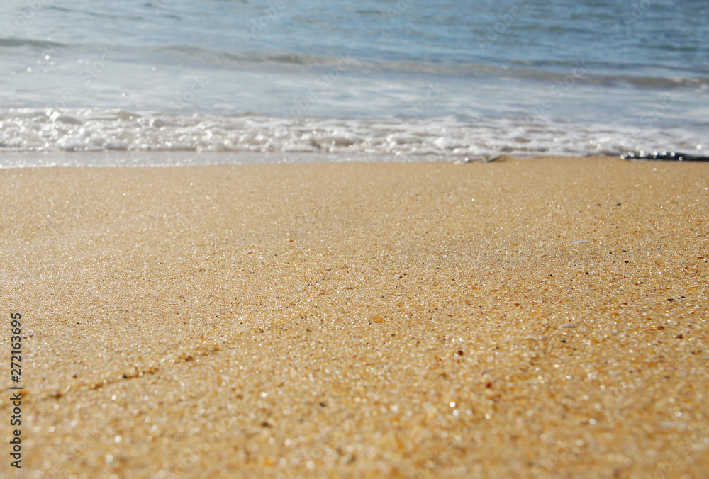 Sand closeup on the shore on the tropical island of Sri Lanka in summer.