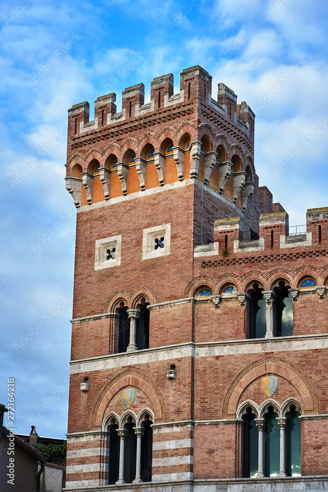 Tower of a renaissance brick building in the city of Grosseto, Italy.