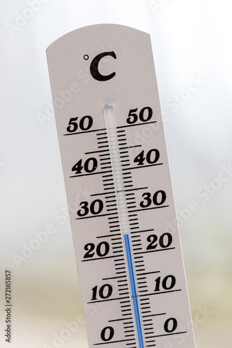Heatwave: Thermometer in summer on a blurry background, heat