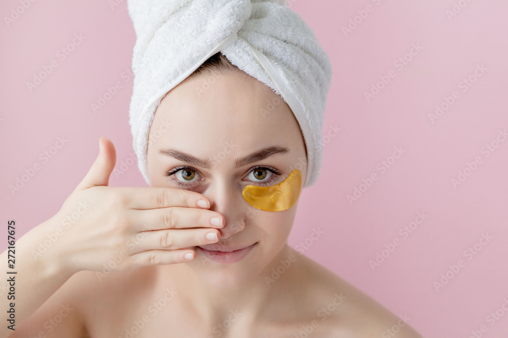 Portrait of Beauty Woman with Eye Patches on pink background. Woman Beauty Face with Mask under Eyes. Beautiful Female with natural Makeup and Gold Cosmetics Collagen Patches on Fresh Facial Skin Portrait of Beauty Woman with Eye Patches on pink background. Woman Beauty Face with Mask under Eyes. Beautiful Female with natural Makeup and Gold Cosmetics Collagen Patches on Fresh Facial Skin