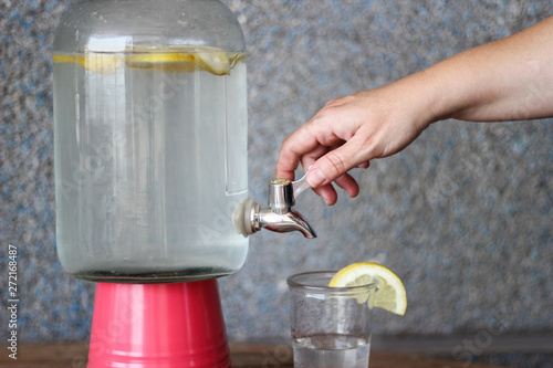 Wallpaper Mural woman's hand serving a lemonade from a large glass bowl Torontodigital.ca