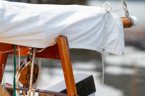 Old sailboat with sail and pulley photo