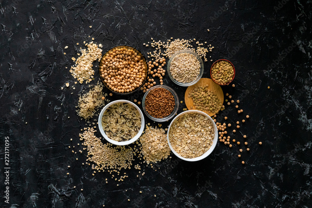 selection of raw uncooked cereals grains in bulbs with chickpeas oat lentil rice buckwheats selection of raw uncooked cereals grains in bulbs with chickpeas oat lentil rice buckwheats