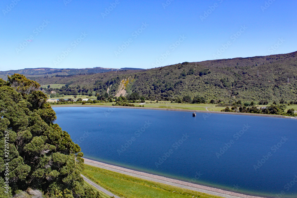 Clear blue reservoir set in the hills in North Island, New Zealand