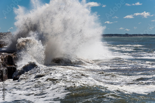 sea waves breaking against a rocky shore