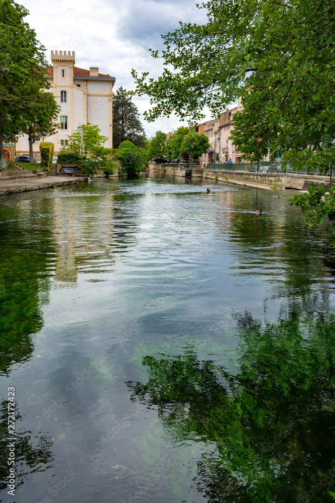 Tourist and vacation destination, small Provencal town lIsle-sur-la-Sorgue with green water of Sotgue river