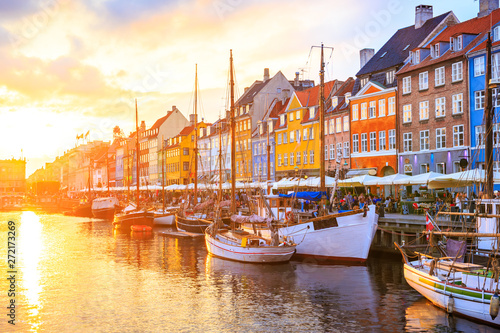 Nyhavn canal in Copenhagen  Denmark - row of colorful houses under sunset colors in the sky.