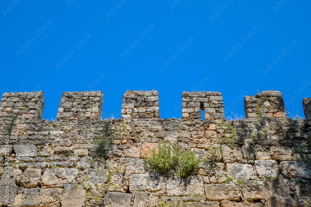 Loopholes of the limestone wall. The fortress wall of the ancient fortress in Antalya