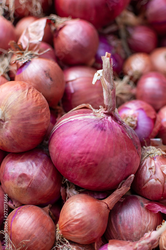 Young fresh red onion on market, new harvest, close up