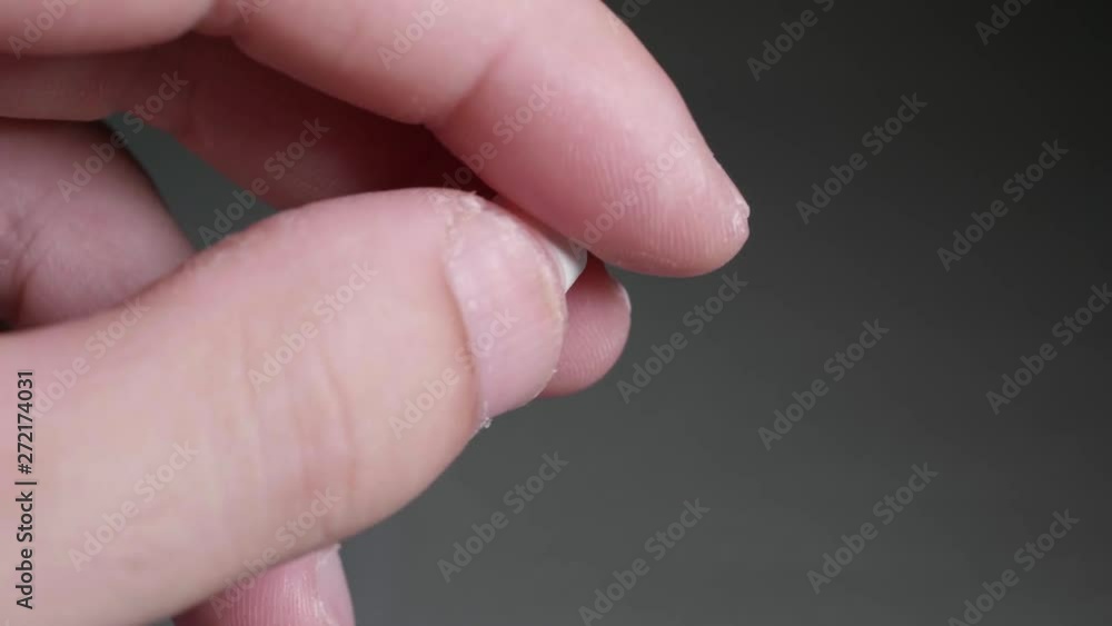Fingers playing with white pill. 4k video macro shot Fingers playing with white pill. 4k video macro shot