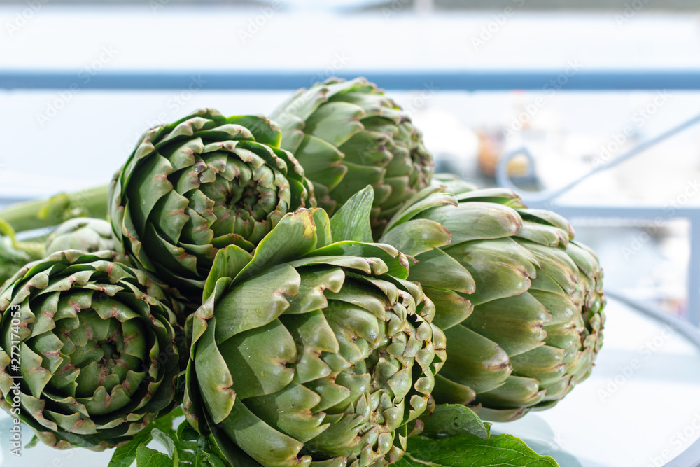 Obraz premium Bunch of fresh raw artichokes heads from artichoke plantation in Argolida, Greece ready to cook