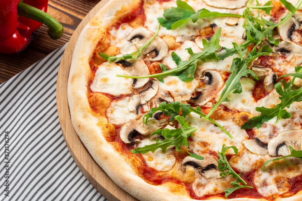 Italian Delicious Fresh Hot Mix Baked Pizza with Melting Cheese, sliced mushrooms , tomato sauce and cheddar serving on textured rustic background. Mushrooms pizza. top view. Italian Delicious Fresh Hot Mix Baked Pizza with Melting Cheese, sliced mushrooms , tomato sauce and cheddar serving on textured rustic background. Mushrooms pizza. top view.