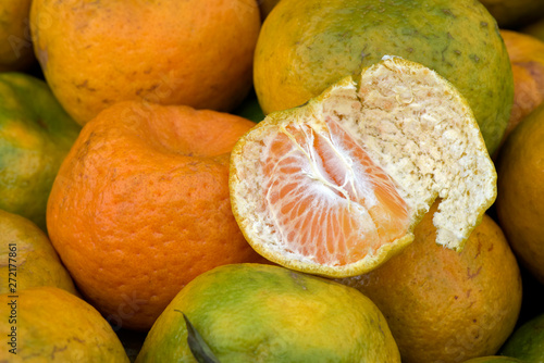 Closeup of tangerine heap, peeled and whole photo