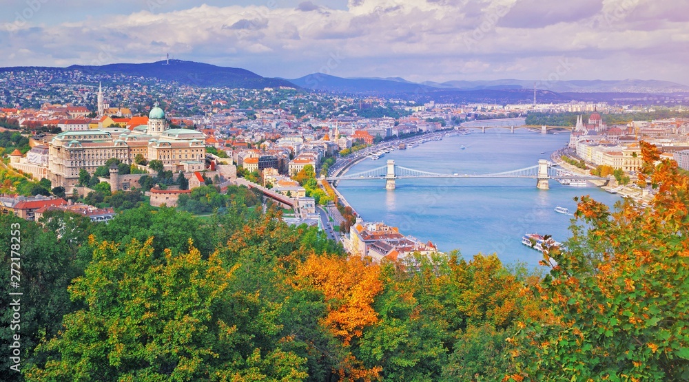 Fototapeta premium Budapest, Hungary. Beautiful aerial panoramic skyline view of historic Buda Castle Royal Palace sunrise blue sky clouds. Hungarian landmark Szechenyi Chain Bridge, Parliament building and Danube river