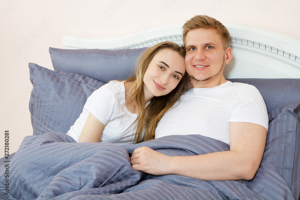 happy couple in love on morning bed, Young loving couple in the bed, Young couple having having romantic times in bedroom happy couple in love on morning bed, Young loving couple in the bed, Young couple having having romantic times in bedroom
