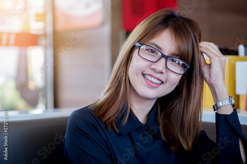 Fototapeta Naklejka Na Ścianę i Meble -  Happy smile of Asian young woman with dental braces and eyeglasses.