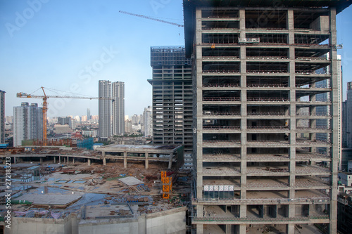 Buildings under construction. Chengdu, Sichuan, China. Construction site in downtown city during blue summer day. 