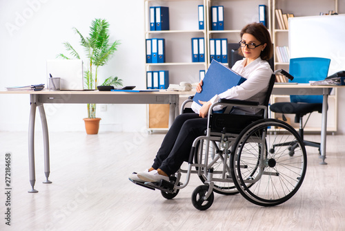 Female employee in wheel-chair at the office 