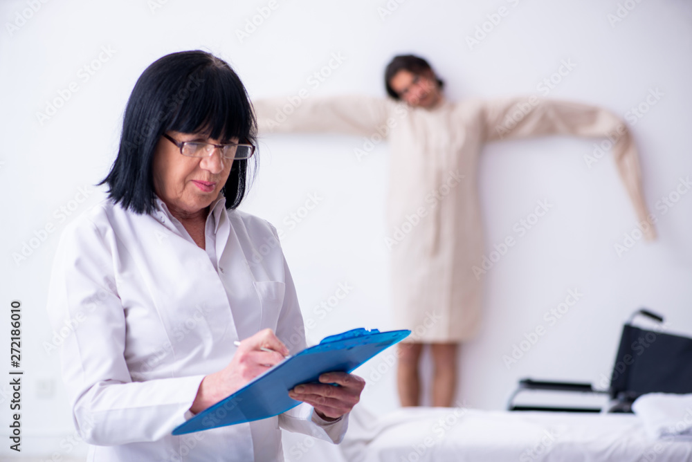 Old female psychiatrist visiting young male patient Old female psychiatrist visiting young male patient