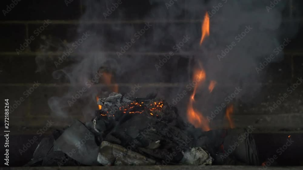 In the stone oven burning wooden coals. Gray smoke rises. The furnace is made of blocks. Large view of the fire. Street situation. Cafe, restaurant, house. Hotter the flames.Video in 4K. In the stone oven burning wooden coals. Gray smoke rises. The furnace is made of blocks. Large view of the fire. Street situation. Cafe, restaurant, house. Hotter the flames.Video in 4K.