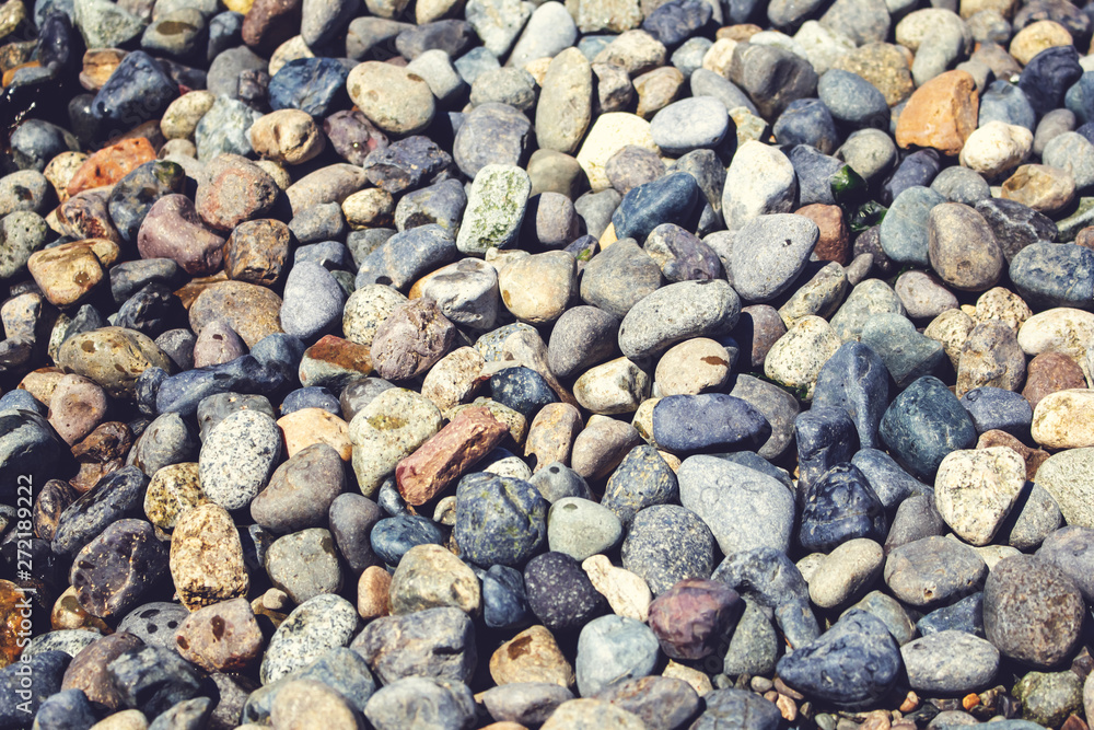 A background of pebbles and rocks near the shoreline A background of pebbles and rocks near the shoreline
