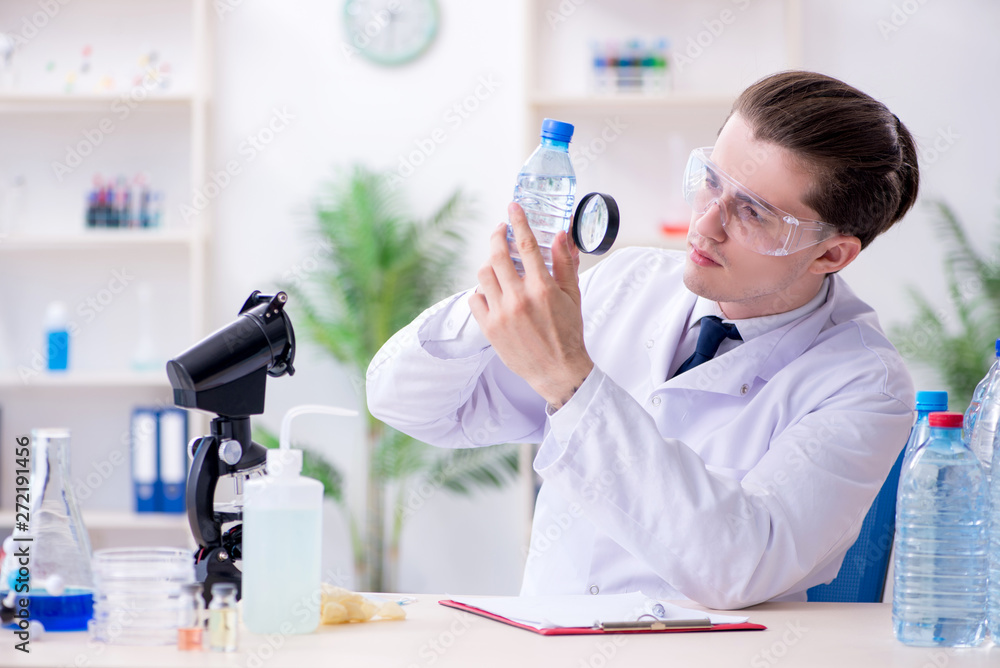 Young male chemist experimenting in lab Young male chemist experimenting in lab