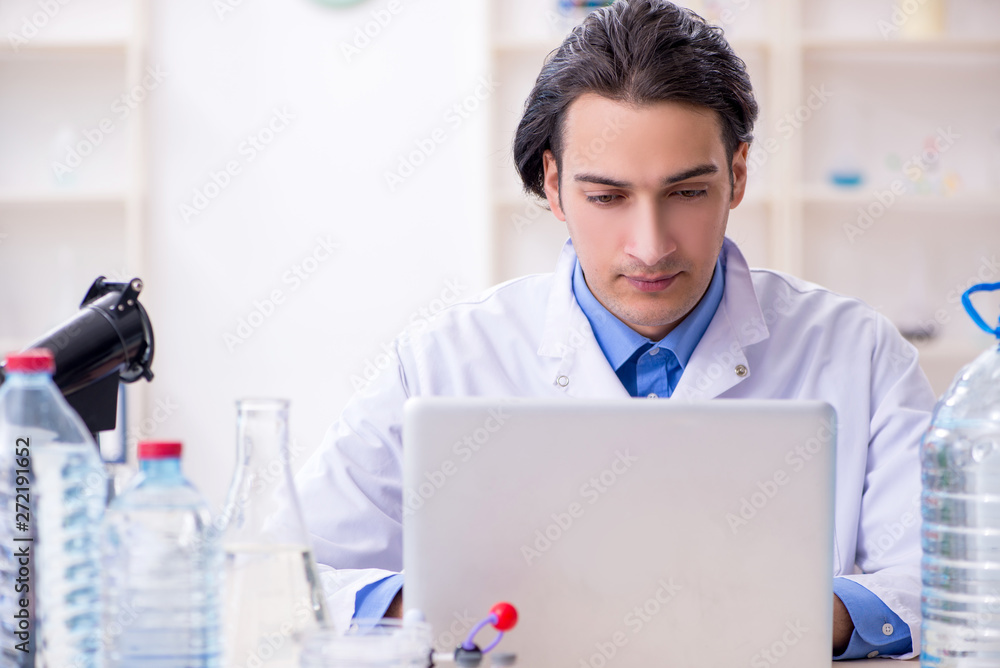 Young male chemist experimenting in lab Young male chemist experimenting in lab