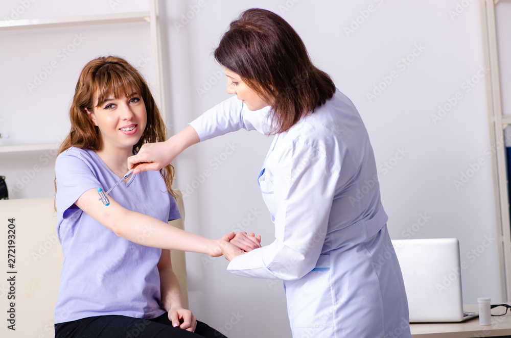 Fototapeta premium Young woman visiting female doctor physiotherapist 