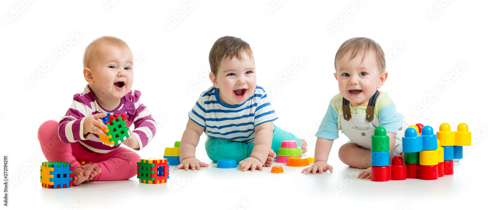 Nursery babies toddlers playing with color toys isolated on white background - obrazy, fototapety, plakaty 