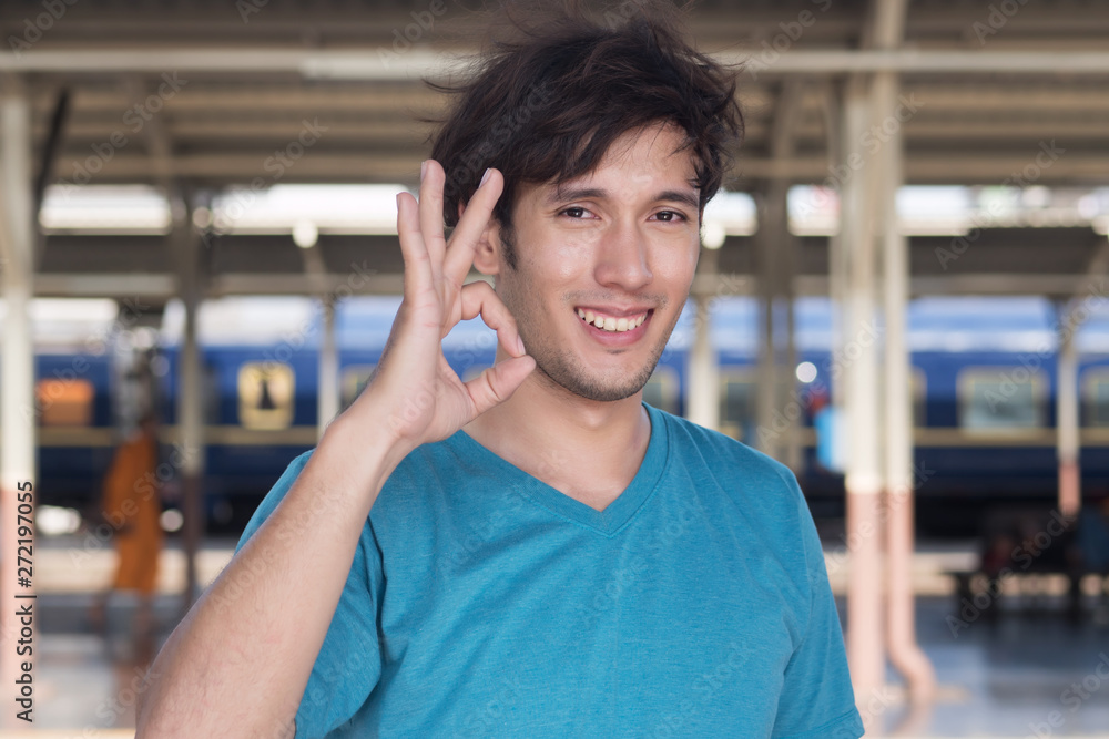 Obraz premium man pointing up ok hand sign; good, correct, ok, accepting, approving concept