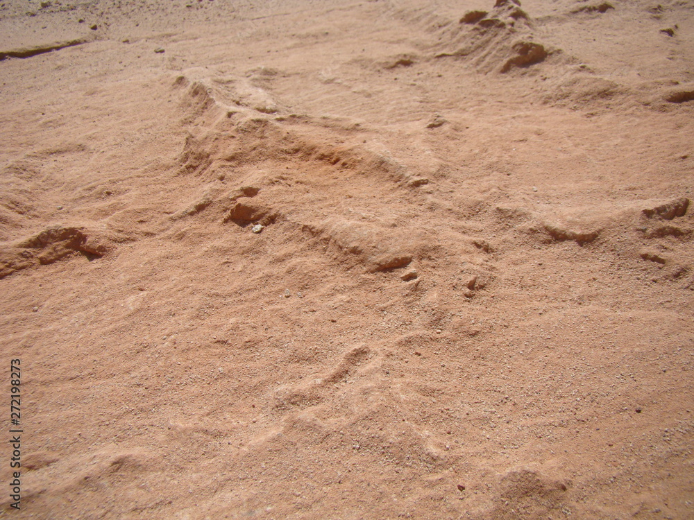 Abstract background - red earth and sand. Rocky elevations. View from top. The concept of the surface of the planet Mars. Abstract background - red earth and sand. Rocky elevations. View from top. The concept of the surface of the planet Mars.