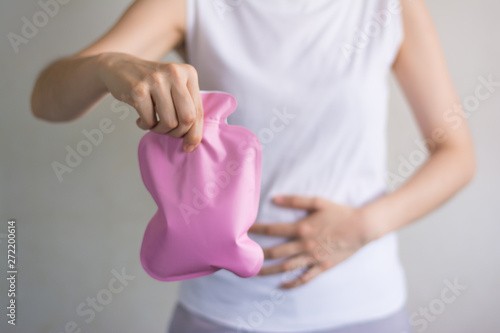 Close up woman has abdominal pain, woman's belly with hot water bottle,Close up woman use Hot Pack