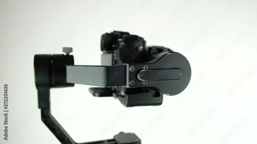 New innovative three-axis stabilizer with digital camera rotates on white background. 4k. Presentation. New innovative three-axis stabilizer with digital camera rotates on white background. 4k. Presentation.