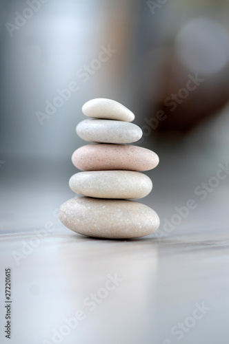 Harmony and balance  cairns  simple poise pebbles on wooden light white gray background  simplicity rock zen sculpture