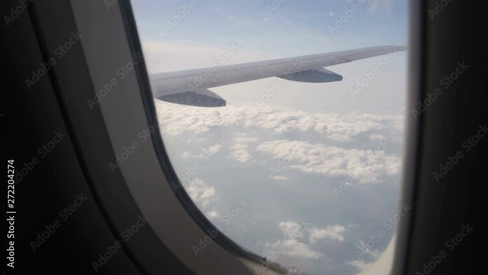 Airplane flight. Wing of an airplane flying above the cloud Airplane flight. Wing of an airplane flying above the cloud
