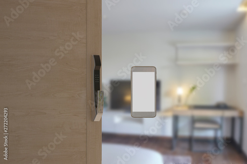 Digital door lock installed on wood door for security and access the room. Electronics knob door access security system by smartphone. Blank smartphone screen for application or contents.