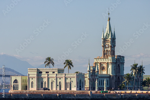 Rio de Janeiro, Brazil -June 07, 2019: The historical building and Fiscal Island (Ilha Fiscal) in the Guanabara bay attached to the naval island with military ship in the background