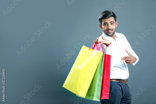 Young indian man with shopping bags