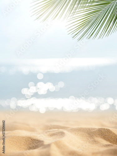 Fototapeta Naklejka Na Ścianę i Meble -  Sand with blurred Palm and tropical beach bokeh background, Summer vacation and travel concept. Copy space