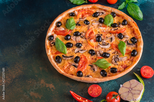 Tasty fresh hot pizza against a dark background. Pizza, food, vegetable, mushrooms. It can be used as a background