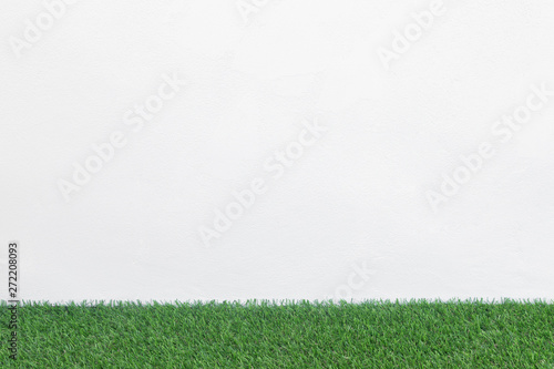 Green grass floor with white concrete background, Mockup for design.