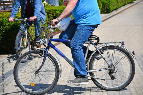 Men on the street wiht bicycles