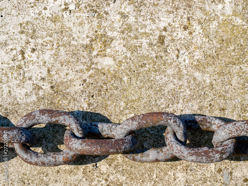 Iron chain on concrete pier.