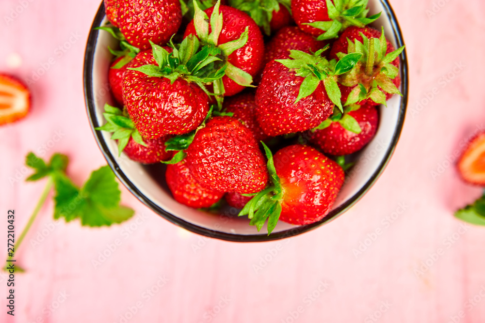 Ripe red strawberries on pink table, Strawberries in bowl. Fresh strawberries. Beautiful strawberries. Diet food. Healthy, vegan. Top view. Flat lay. Ripe red strawberries on pink table, Strawberries in bowl. Fresh strawberries. Beautiful strawberries. Diet food. Healthy, vegan. Top view. Flat lay.